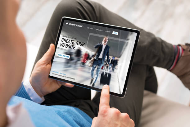 Caucasian ethnicity male using tablet for creating website for his business