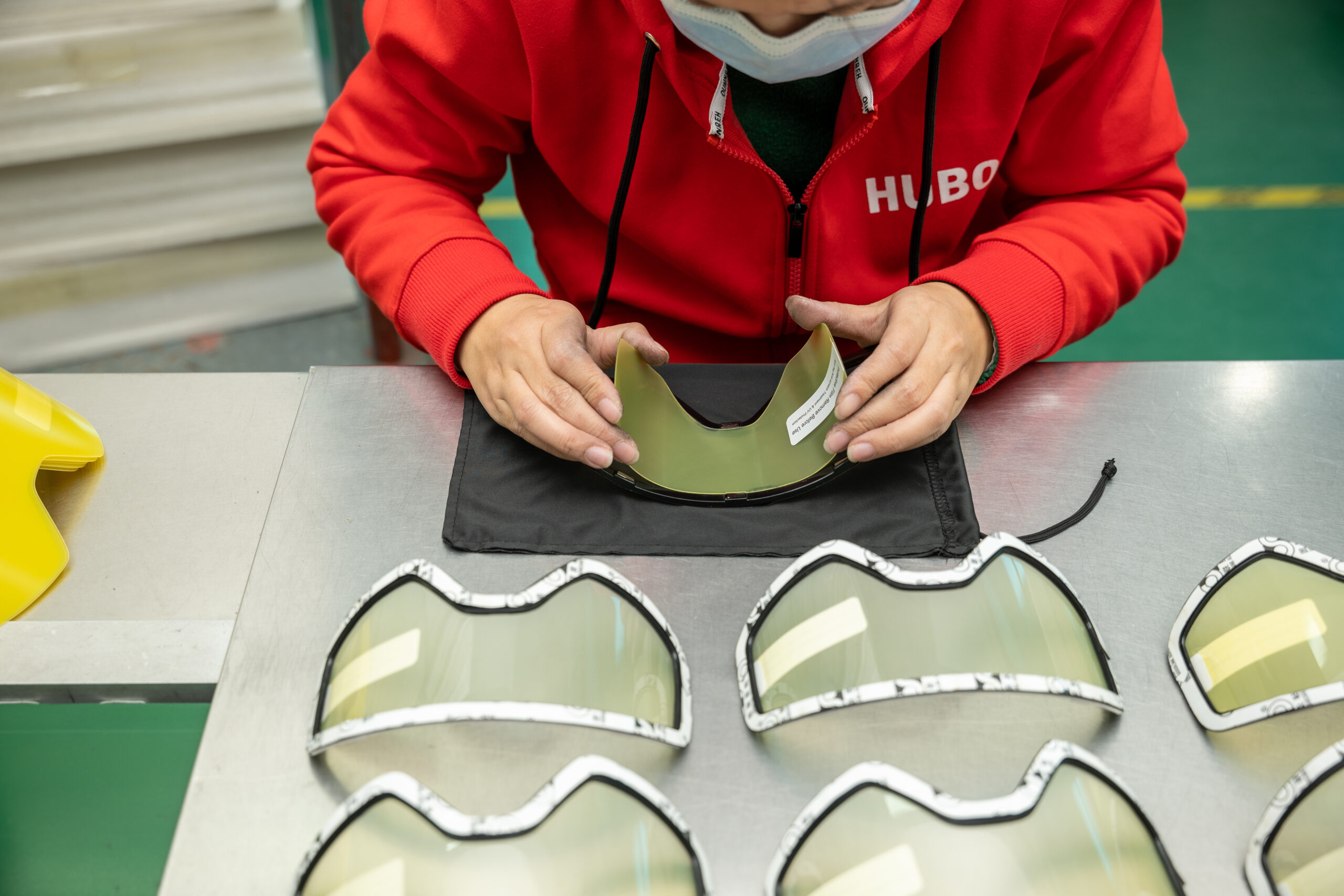 Laminating protective films onto lenses